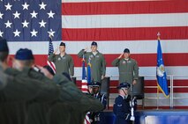 U.S. Air Force Airmen salute the flag as the base honor guard presents the colors at the 55th Fighter Squadron change of command ceremony, Shaw Air Force Base, S.C., June 15, 2012. Lt. Col. Christopher Claus assumed command in place of Lt. Col. Micheal Schnabel, prior 55th Fighter Squadron commander.(U.S. Air Force Airman Nicole Sikorski/Released)