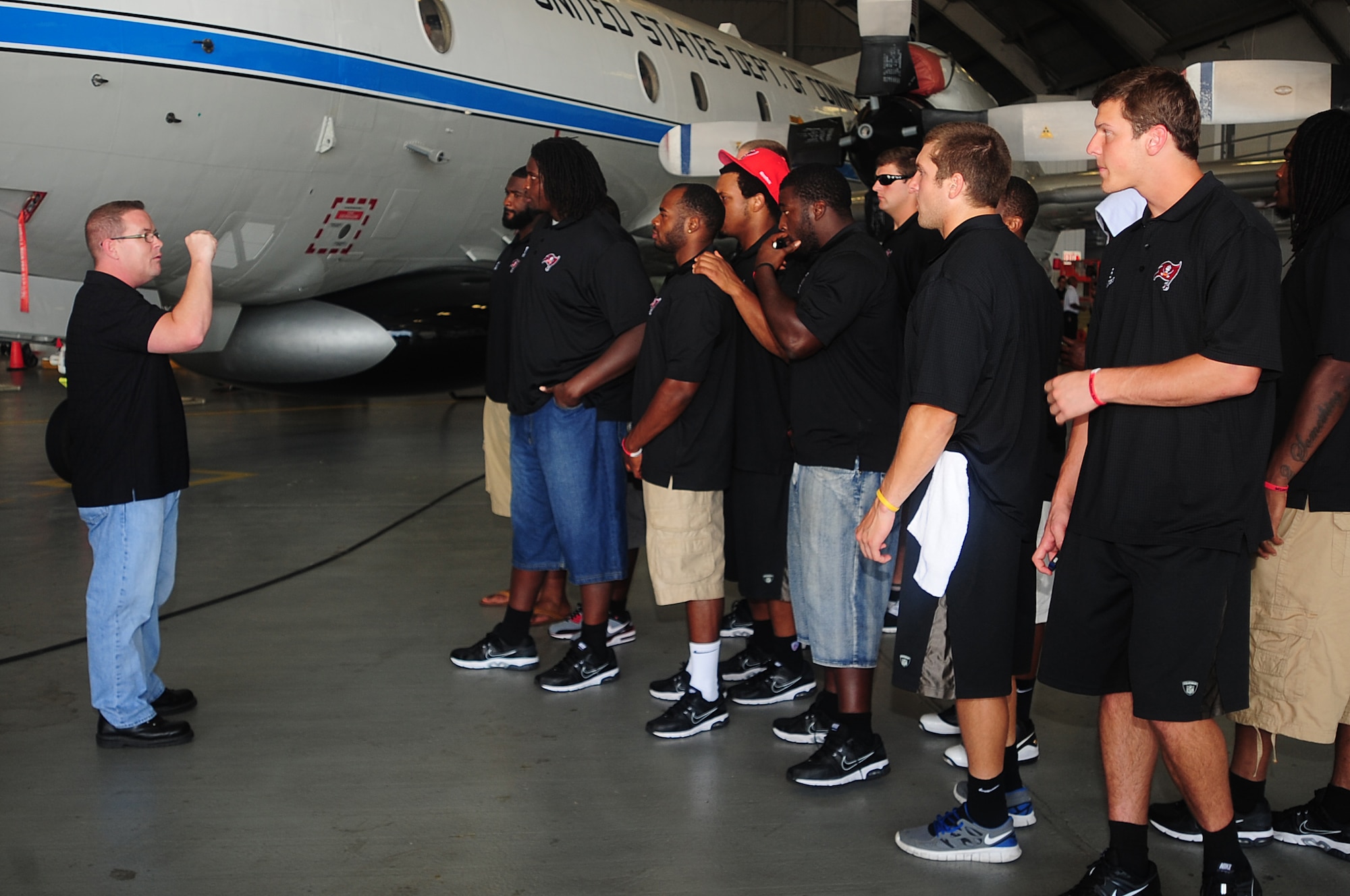 Members of the Tampa Bay Buccaneers tour the National Oceanic and Atmospheric Administration air craft at MacDill Air Force Base, Fla., June 15, 2012. Players from the Bucs toured MacDill and experienced some of the daily operations. (U.S. Air Force photo by Senior Airman Melissa V. Paradise/RELEASED/cropped for point of interest)  