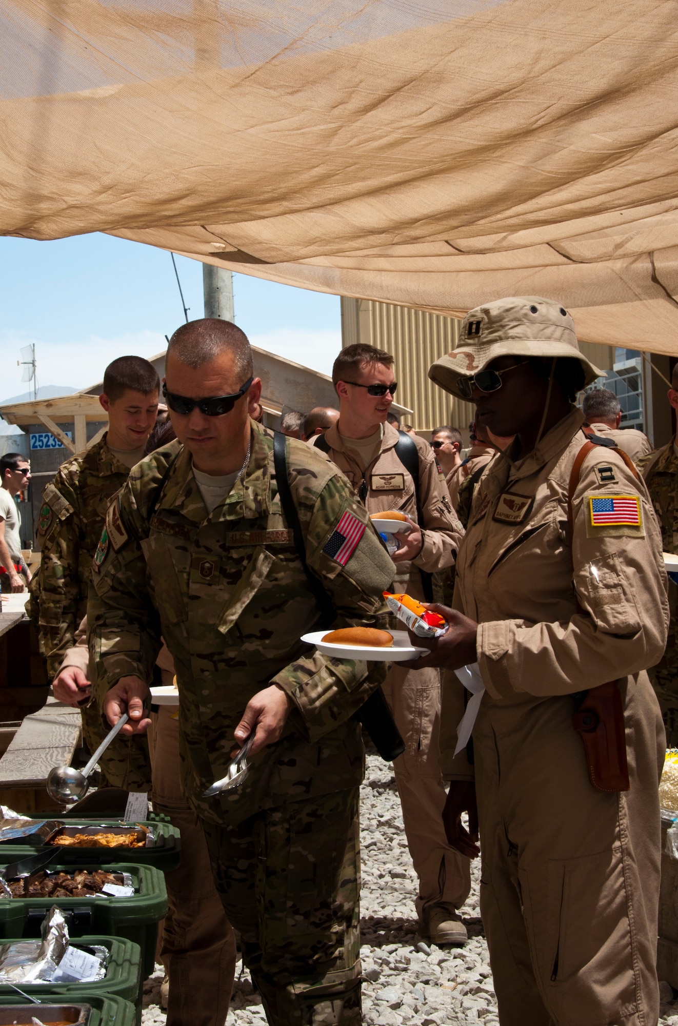 Members of the 50th Airlift Squadron from Little Rock Air Force Base, Ark., and 52nd Airlift Squadron, from Peterson Air Force Base in Colorado Springs, Col., enjoy a rare catered barbeque to briefly celebrate their unit’s 70-year-history while deployed as the 774th Expeditionary Airlift Squadron at Bagram Airfield, Afghanistan. The 50th and 52nd Airlift Squadrons recently deployed as a combined expeditionary squadron. (U.S. Air Force photo/TSgt Shawn McCowan)