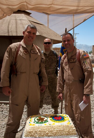 Lt. Col. Tim Julian (right), 50th Airlift Squadron commander, and Lt. Col. Jason Terry, 52nd AS Director of Operations, held a brief celebration honoring their 70th Anniversaries as the combined 774th Expeditionary Airlift Squadron at Bagram Airfield, Afghanistan, while deployed in support of Operation Enduring Freedom. MSgt Scott Czerwinski (back, center) 50th Airlift Squadron first sergeant, also participated as 774th Expeditionary Airlift Squadron first sergeant. (U.S. Air Force photo/TSgt Shawn McCowan)