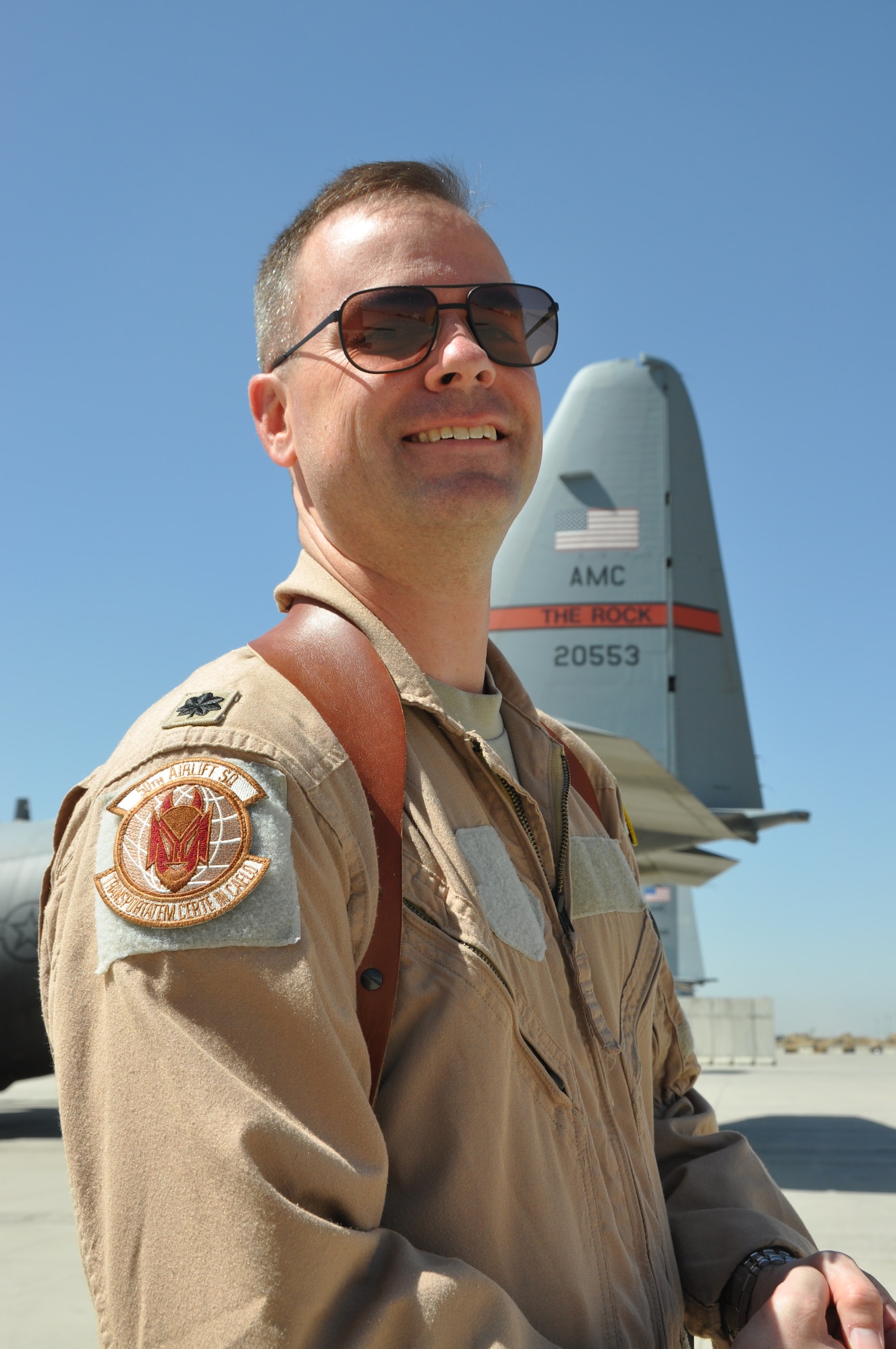 Lt. Col. Tim Julian flashes the emblem of his “Red Devils” among some of his deployed aircraft at Bagram Airfield, Afghanistan. Julian commands both the 50th Airlift Squadron, Little Rock Air Force Base, Ark., and their deployed identity, the 774th Expeditionary Airlift Squadron at Bagram. He was pivotal in tying the 50th and 52nd Airlift Squadrons back together in 2009, when the Air Force decided to create a new Active Associate unit with the 302nd Airlift Wing at Peterson Air Force Base in Colorado Springs, Col. (U.S. Air Force photo/TSgt Shawn McCowan)