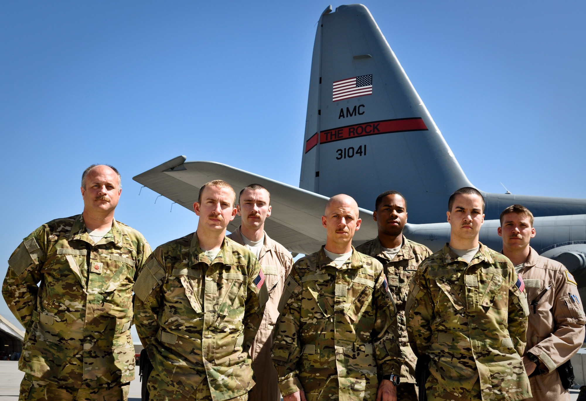 Members of the 50th Airlift Squadron from Little Rock Air Force Base, Ark., pause to reflect on their unit’s 70-year-history before embarking on a mission while deployed as the 774th Expeditionary Airlift Squadron at Bagram Airfield, Afghanistan. The 50th and 52nd Airlift Squadrons recently shared their 70th Anniversary as a combined expeditionary squadron. (U.S. Air Force photo/TSgt Shawn McCowan)