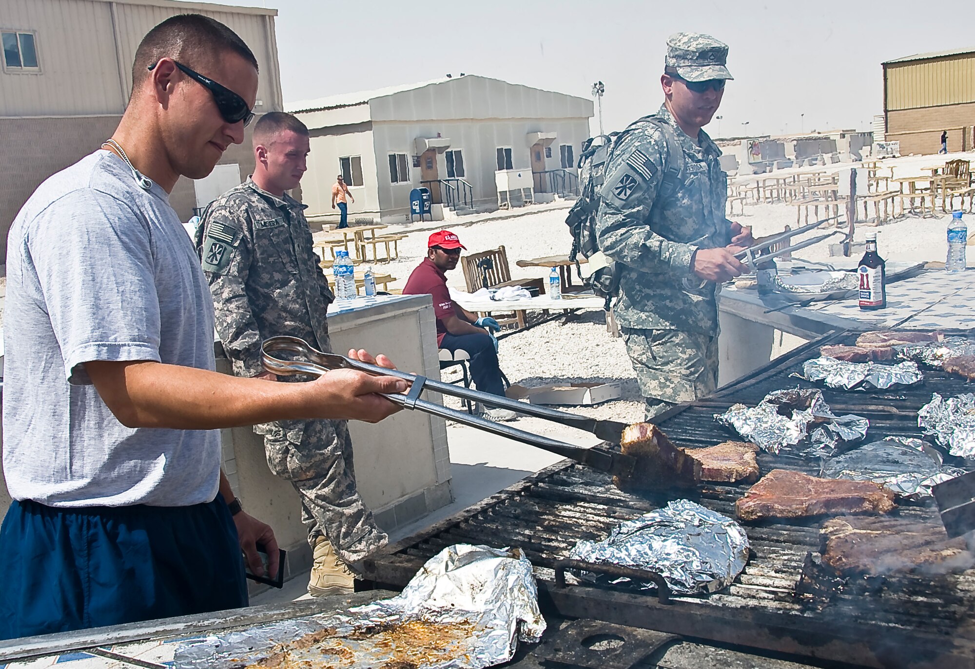 SOUTHWEST ASIA - Service members made the most of their deployed Father’s Day as many marinated and grilled their own T-bone steaks here June 17. The 379th Air Expeditionary Wing provided home-comfort activities to deployed service members who are supporting ongoing contingency operations in Southwest Asia. (U.S. Air Force photo/Senior Airman Bryan Swink)