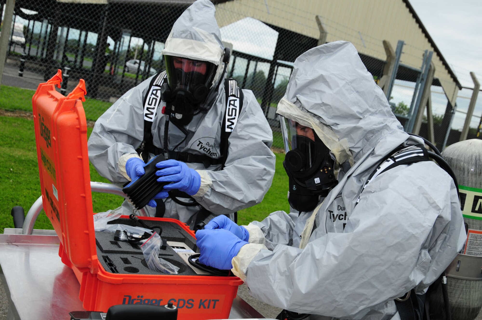 RAF MILDENHALL, England -- Airman 1st Class Joshua Foxworth and Staff Sgt. Jesse Furse, both 100th Civil Engineer Squadron Emergency Management, go through their chemical detection kit prior to air sampling the outside of the possibly hazardous vehicle during an exercise here June 12, 2012. The exercise scenario consisted of a chemical suicide in a vehicle, where a simulated unconscious person was found inside the car which was sealed up and was seen to have a bucket with an unknown substance inside, along with containers of household chemicals and cleaning products which, when mixed together, could produce a hazard. (U.S. Air Force photo/Karen Abeyasekere)