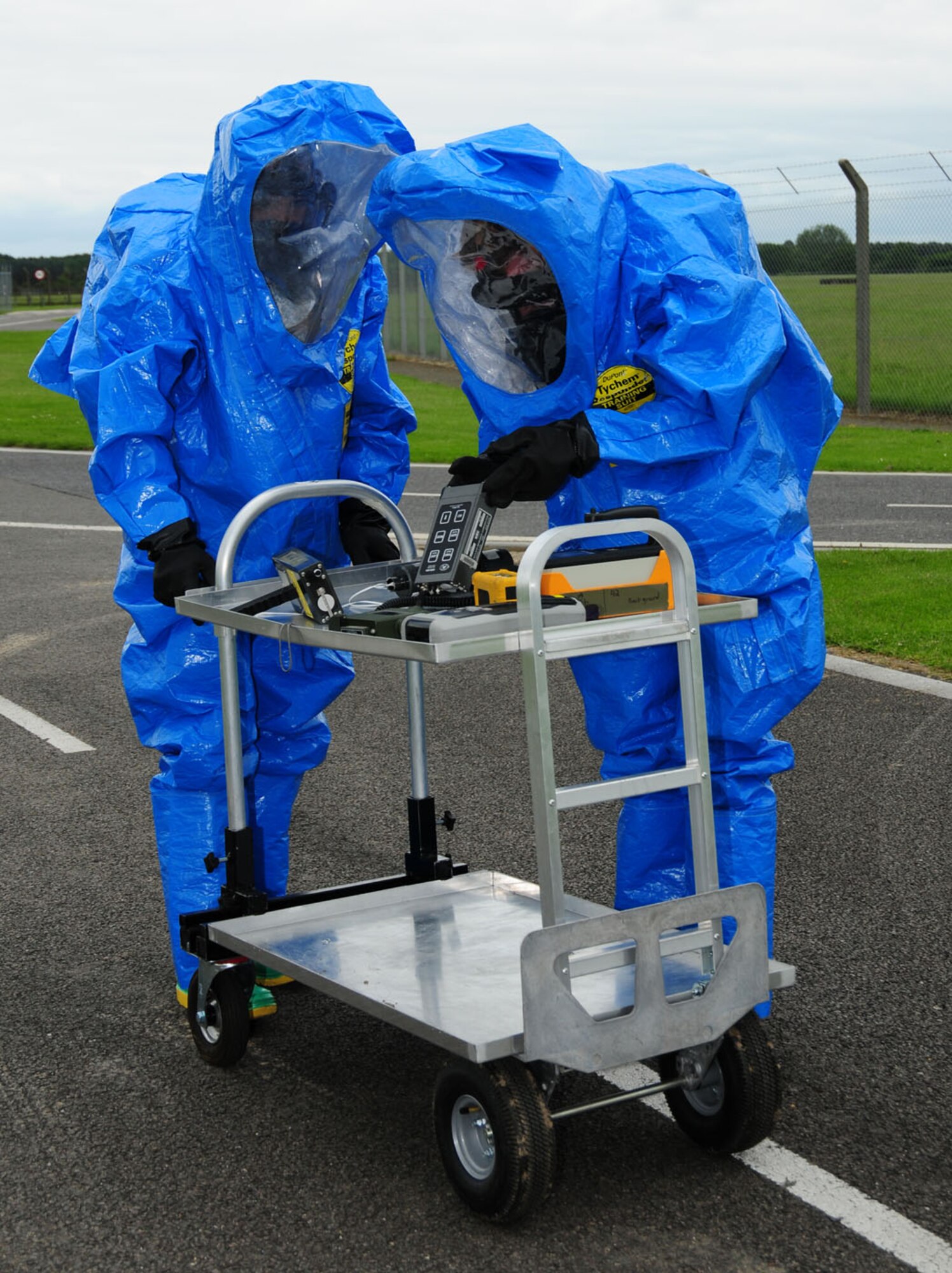 RAF MILDENHALL, England – Senior Airman Scott Floyd, a reservist with the 434th Civil Engineer Squadron, Grissom Air Reserve Base, Ind., and Airman 1st Class Marco Misko, 100th Civil Engineer Squadron, check their sampling equipment for readings as they get close to a vehicle that could possibly be contaminated, in a hazardous materials response exercise here June 12, 2012. (U.S. Air Force photo/Karen Abeyasekere)