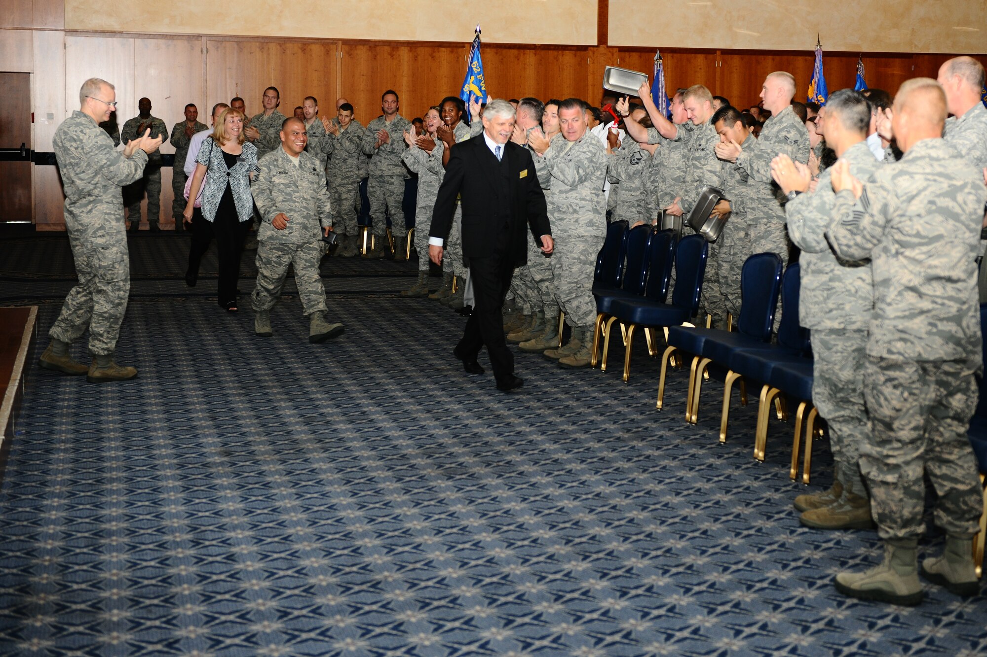 SPANGDAHLEM AIR BASE, Germany – Airmen from the 52nd Fighter Wing show support for the Eifel Arms Inn lodging staff as they welcome the Air Force Services Agency Innkeeper Award review team before the in-brief inside the Club Eifel ballroom here June 18. The Eifel Arms Inn is competing for the 2012 Air Force Best Small Lodging Operation against three other lodging facilities. (U.S. Air Force photo by Airman 1st Class Matthew B. Fredericks/Released)