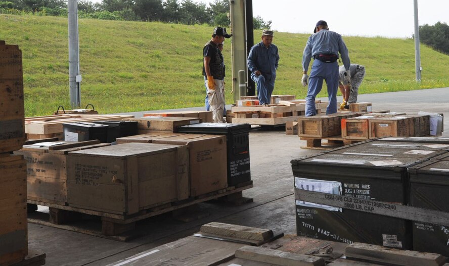 Members of the Japanese palletization team prepare to build a brace to ship unserviceable products at Misawa Air Base, Japan, June 19, 2012. The team helped ship out over $19 million of unserviceable munitions. (U.S. Air Force photo by Airman Kenna Jackson/Released)