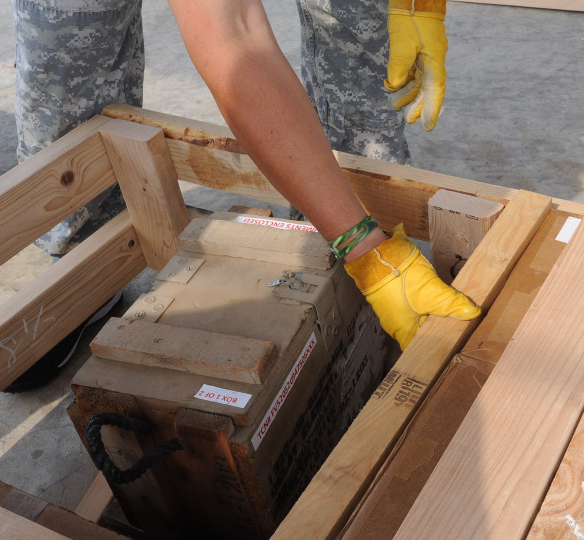 Kazuya Sugihara, Japanese palletization team member, builds a brace around unserviceable munitions at Misawa Air Base, Japan, June 19, 2012. The brace is a wooden crate built to compartmentalize and secure the unserviceable munitions. (U.S. Air Force photo by Airman Kenna Jackson/Released)