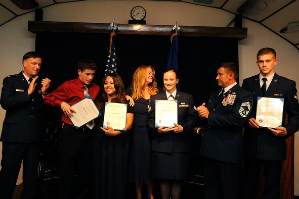 The four Brantley children are presented with certificates of appreciation from their parents during Chief Master Sgt. John Brantley's retirement ceremony, May 18, 2012, at Barksdale Air Force Base, La. When someone makes a dedication to serving in their country's military, their family members are affected in many ways. (U.S. Air Force photo/Airman 1st Class Andrew Moua)