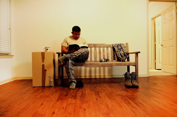In an empty apartment, Chief Master Sgt. John Brantley reads his Bible and drinks coffee during one of his last days of 27 years serving in the Air Force, May 15, 2012, in Bossier City, La. Brantley shared the experience of moving 12 times in his career with his wife Cornelia and their four children, two of whom are also now Airmen. (U.S. Air Force photo/Senior Airman Brigitte N. Brantley)