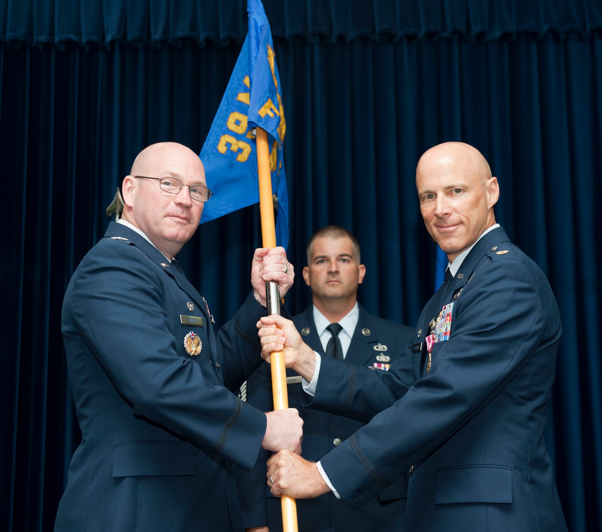 Maj. Thomas Ausherman, outgoing 39th Force Support Squadron commander, relinquishes command of the 39th FSS to Col. Scott Enold, 39th Mission Support Group commander, during the change-of-command ceremony June 18, 2012 at Incirlik Air Base, Turkey. Ausherman will be replaced by Lt. Col. Bernadette Bowman. (U.S. Air Force photo by Senior Airman Clayton Lenhardt/Released)