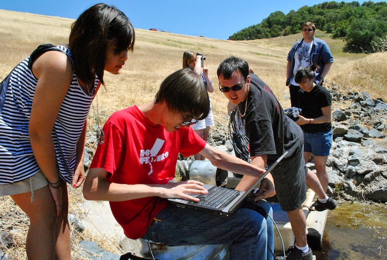 UKIAH, Calif. -- Members of the Vallejo High School robotics team in California, The Zombots, look at images transmitted by a robot they built. The team brought their robot, named Charles, to the Coyote Dam here to assess the interior conditions of a pipe that runs along the dam.