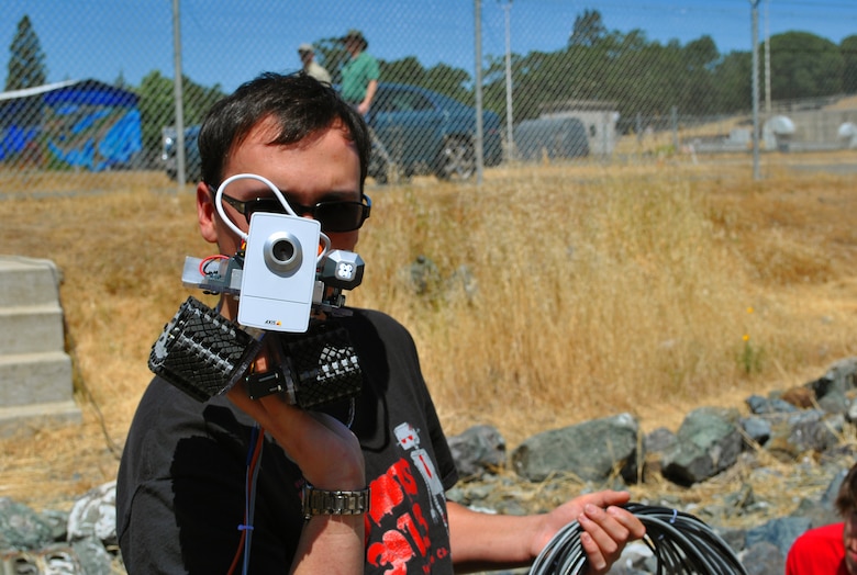 UKIAH, Calif. -- Anthony Kee, a member of the Vallejo High School robotics team in California, The Zombots, holds the robot he and fellow teammates built.