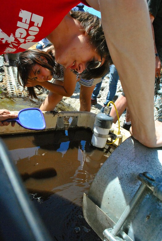 UKIAH, Calif. -- Angela Ituriaga and Zachary Christilaw, members of the Vallejo High School robotics team in California, The Zombots, search for a robot in a large, narrow pipe along the Coyote Dam. The robot's purpose was to assess the interior conditions of the pipe, essentially checking for any degradation.