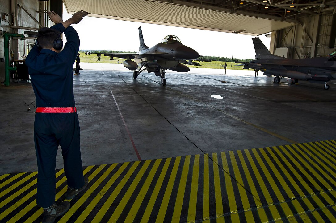 U.S. Air Force Airman 1st Class William Orlandi marshals in a U.S. Air Force F-16C Fighting Falcon after a combat-training mission during Red Flag-Alaska 12-2 on Eielson Air Force Base, Alaska, June 18, 2012. Orlandi is a crew chief assigned to the 51st Aircraft Maintenance Squadron, Osan Air Base, South Korea.