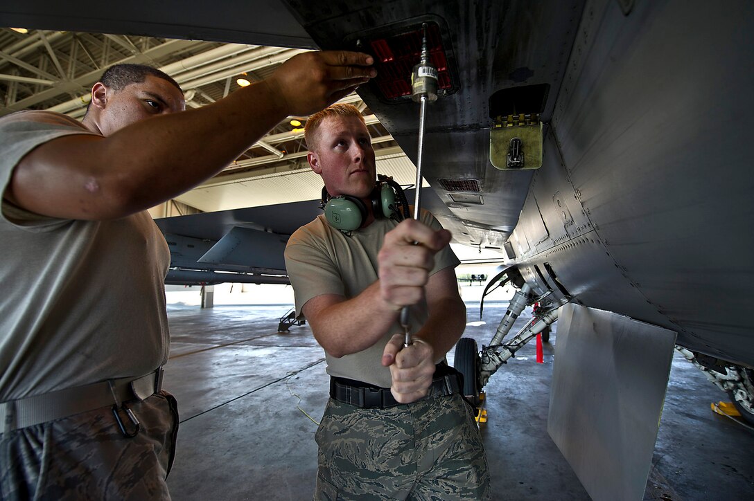 U.S. Air Force Senior Airman Dusty Filemoni and Staff Sgt. Brandon Smith replace the chaff and flares on a 36th Fighter Squadron F-16C Fighting Falcon during Red Flag-Alaska 12-2 on Eielson Air Force Base, Alaska, June 18, 2012. Filemoni and Smith  are aircraft armament systems specialists assigned to the 51st Aircraft Maintenance Squadron, Osan Air Base, South Korea.
