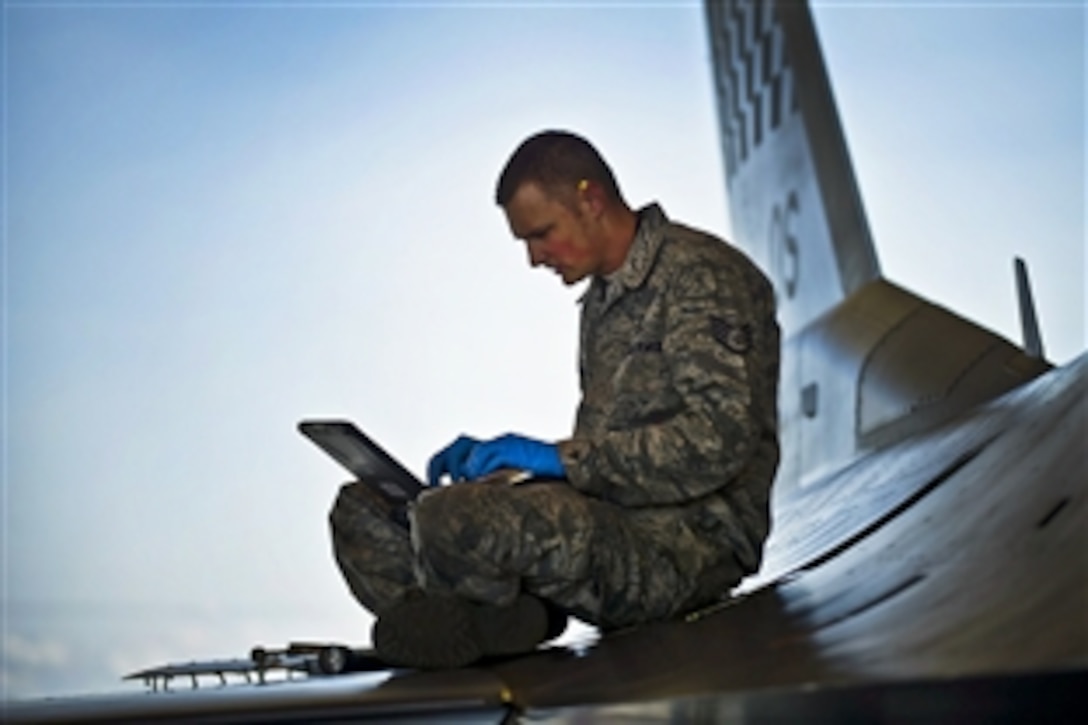 U.S. Air Force Staff Sgt. James Broome references an electronic technical order for an F-16C Fighting Falcon during Red Flag-Alaska 12-2 on Eielson Air Force Base, Alaska, June 18, 2012. Broome is a crew chief assigned to the 51st Aircraft Maintenance Squadron, Osan Air Base, South Korea.