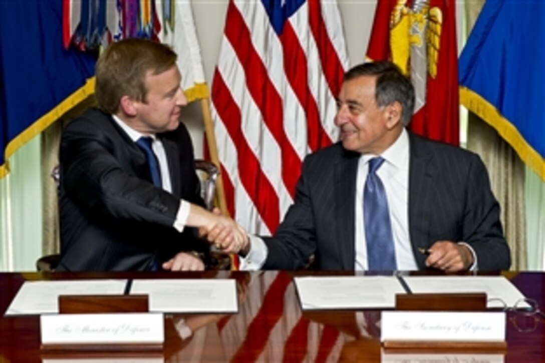 U.S. Defense Secretary Leon E. Panetta, right, and New Zealand Defense Minister Jonathan Coleman sign a defense cooperation arrangement at the Pentagon, June 19, 2012, to expand the defense relationship between the two countries and promote a common vision for defense cooperation.