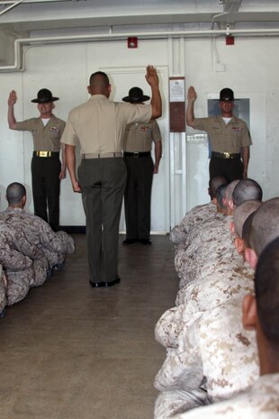Capt. Juan Plancarte, series commander, Company B, 1st Recruit Training Battalion, recites the drill instructor creed as his instructors echo his word June 8 aboard Marine Corps Recruit Depot San Diego. Pick up day is where the recruits learn what their drill instructors expect of them and get the first tast of what the next 12 weeks will be like.