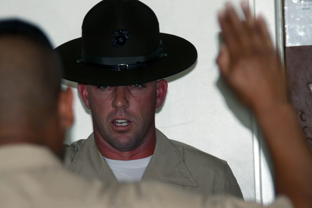 Staff Sgt. Robert Phelan, senior drill instructor, Platoon 1021, Company B, 1st Recruit Training Battalion, echos the drill instructor creed as his series commander recites during pick up June 8 aboard Marine Corps Recruit Depot San Diego. The creed says the drill instructors take responsibilty for their recruits and will train them to the best of their ability. This starts training day one out of 12 weeks.