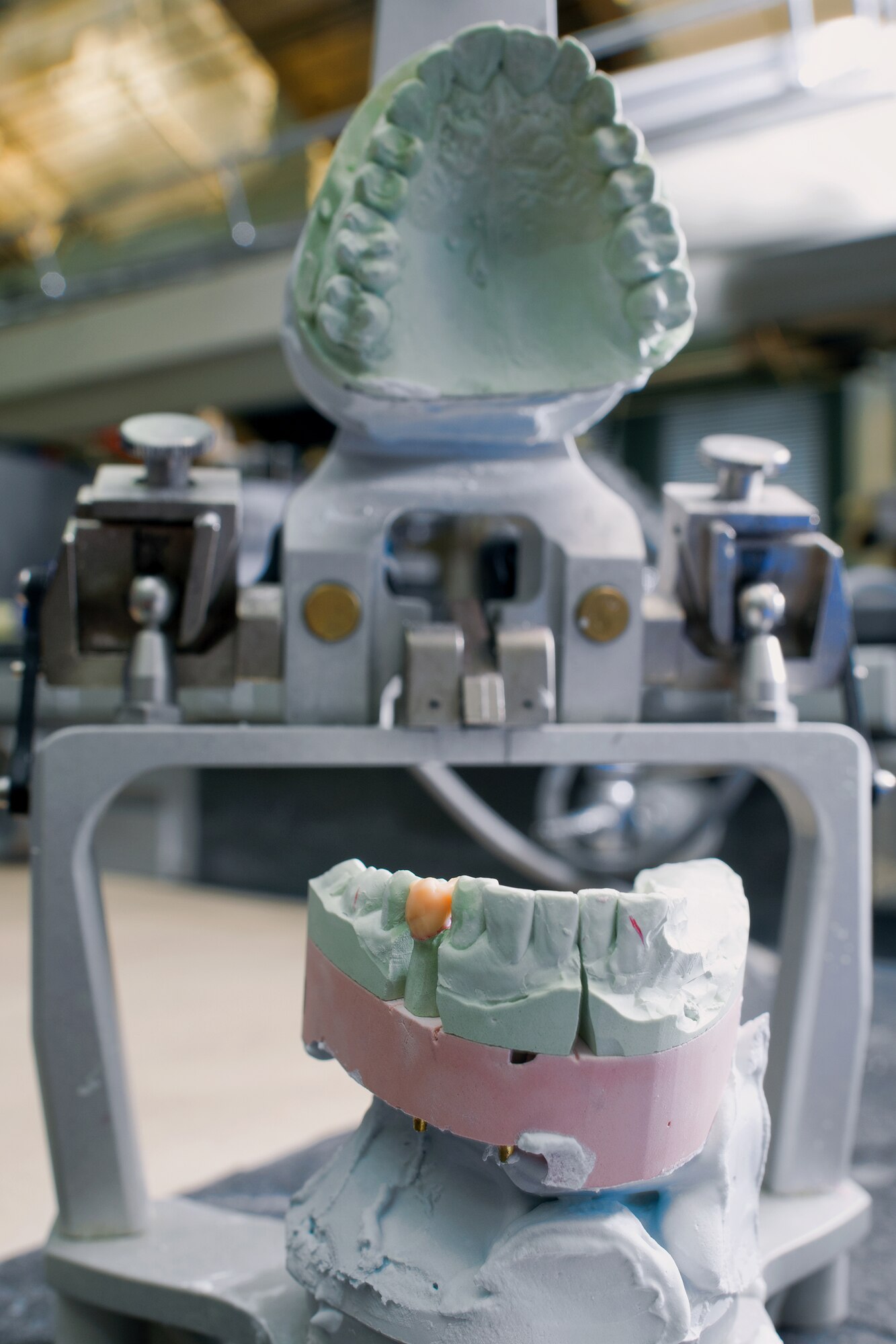 YOKOTA AIR BASE, Japan -- A Yokota dental laboratory technician finishes a single unit crown onto a clay cast of teeth at Yokota Air Base, Japan, on June 19, 2012. The lab provides more than 1,000 crowns annually to patients. (U.S. Air Force photo by Osakabe Yasuo) 