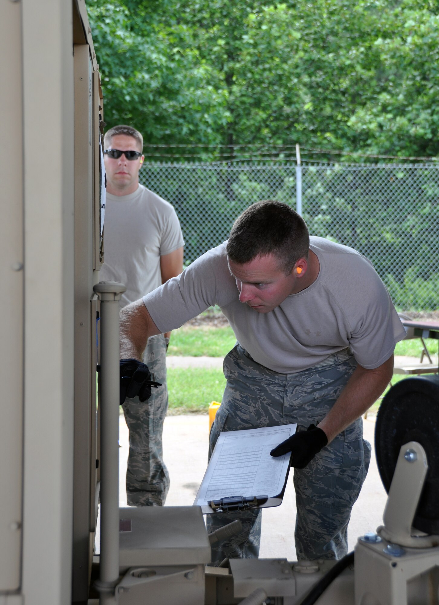 Senior Airman Daniel Taylor, of the 80th Aerial Port Squadron, checks for discrepancies with potential cargo, during a cargo inspection challenge at this year’s Port Dawg Challenge June 20 at Dobbins ARB. Master Sgt. Matthew Russell, of the 27th APS from Minneapolis-St. Paul Air Reserve Station observes Taylor. Teams compete in various challenges to showcase their capabilities as aerial porters. (U.S. Air Force photo/Senior Airman Elizabeth Gaston)