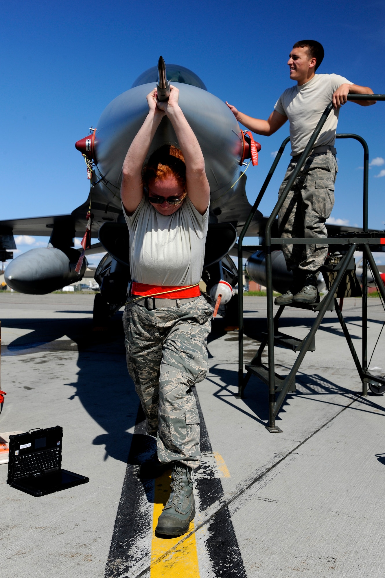 U.S. Air Force Senior Airman Katherine McCoary and Airman 1st Class Brice Lothe, 77th Aircraft Maintenance Unit avionics specialists out of Shaw Air Force Base, S.C., pull open the nose of an F-16 Fighting Falcon during RED FLAG-Alaska 12-2  June 19, 2012, Eielson Air Force Base, Alaska. Once open, the avionics specialists will inspect the aircraft’s radar antenna for air leaks. (U.S. Air Force photo/Staff Sgt. Jim Araos)