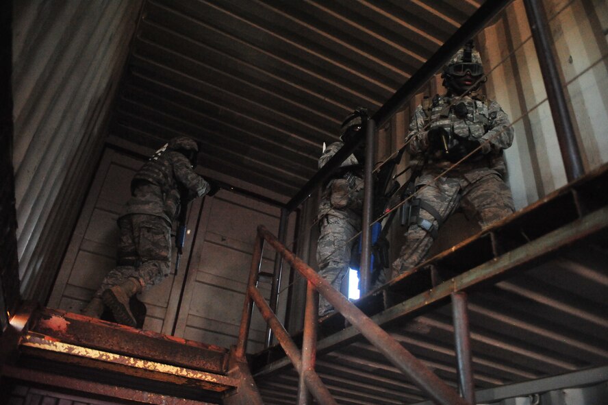 Members of the 27th Special Operations Security Forces Squadron Deployed Aircraft Ground Response Element team practice room clearing procedures on the second floor of a building during a convoy training mission at Melrose Air Force Range, N.M., June 8, 2012. The DAGRE team is trained to adapt security missions to support Special Operations Forces worldwide. (U.S. Air Force photo by Airman 1st Class Eboni Reece)