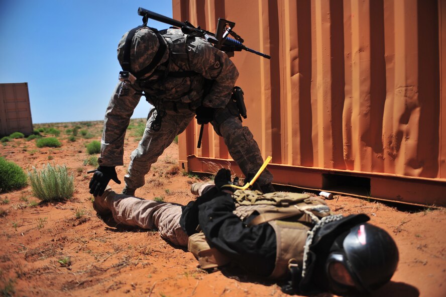 U.S. Air Force Staff Sgt. Douglas Freeman, 27th Special Operations Security Forces Squadron Deployed Aircraft Ground Response Element team, performs a search on a captured opposing forces member during a convoy training mission at Melrose Air Force Range, N.M., June 8, 2012. The DAGRE team is trained to adapt security missions to support Special Operations Forces worldwide. (U.S. Air Force photo by Airman 1st Class Eboni Reece)