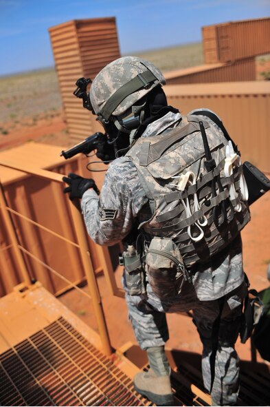 U.S. Air Force Senior Airman Jared Almengor, 27th Special Operations Security Forces Squadron Deployed Aircraft Ground Response Element team, aims his weapon while descending the staircase during a convoy training mission a Melrose Air Force Range, N.M., June 8, 2012. The DAGRE team is trained to adapt security missions to Support Special Operations Forces worldwide. (U.S. Air Force photo by Airman 1st Class Eboni Reece)