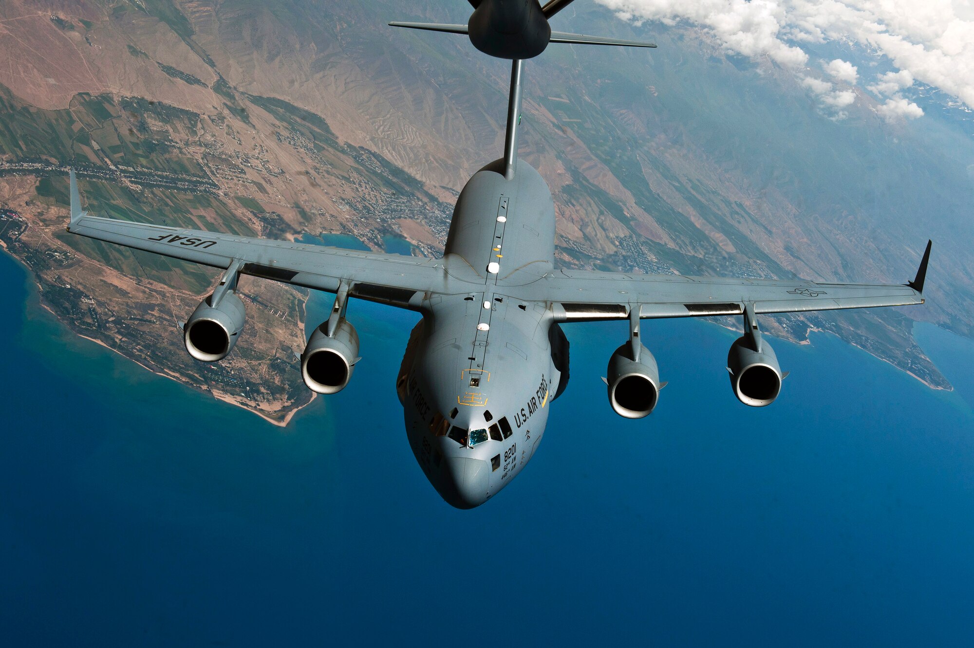 Aircrew deployed from the 62nd Airlift Wing prepare to demonstrate a C-17 Globemaster III's aerial refueling capabilities over Kyrgzystan, June 8, 2012. The crew consisted of Capt. Daniel Hellinger, Capt. David Tomlinson, 1st Lt. Sean Shay, Staff Sgt. Nicholas Cray, deployed from the 8th Airlift Squadron at Joint Base Lewis-McChord, Wash., and Airman 1st Class Clinton Robbins deployed from the 535 Airlift Squadron at Hickam Air Force Base, Hawaii. The crew provided more than 70 minutes of air refueling time with a KC-135 Stratotanker, which held 11 media representatives including both local Kyrgyzstan media along with international media members from Reuters and the Associated Press. The flight was designed to showcase the U.S. Air Force aerial refueling capabilities at the Transit Center at Manas, Kyrgyzstan. The C-17 was in transit transporting personnel and cargo into and out of Afghanistan. (U.S. Air Force photo/Senior Airman Brett Clashman)