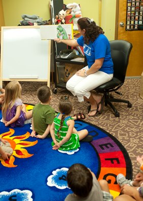 Erin Pearson, 23d Force Support Squadron head library clerk and storyteller, reads a picture book to children in the storytelling room at the library June 20, 2012, at Moody Air Force Base, Ga. Story time is part of the Summer Reading Program, which encourages children to continue reading over the summer. (U.S. Air Force photo by Airman 1st Class Jarrod Grammel/Released)

