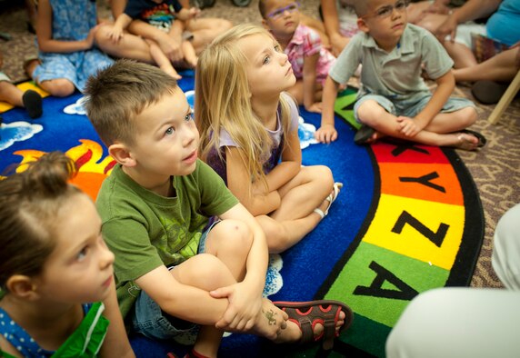 Children sit and listen to a story in the library June 20, 2012, at Moody Air Force Base, Ga. Story time is aimed at children as young as 3 years old to get them interested in reading at a young age. (U.S. Air Force photo by Airman 1st Class Jarrod Grammel/Released)
