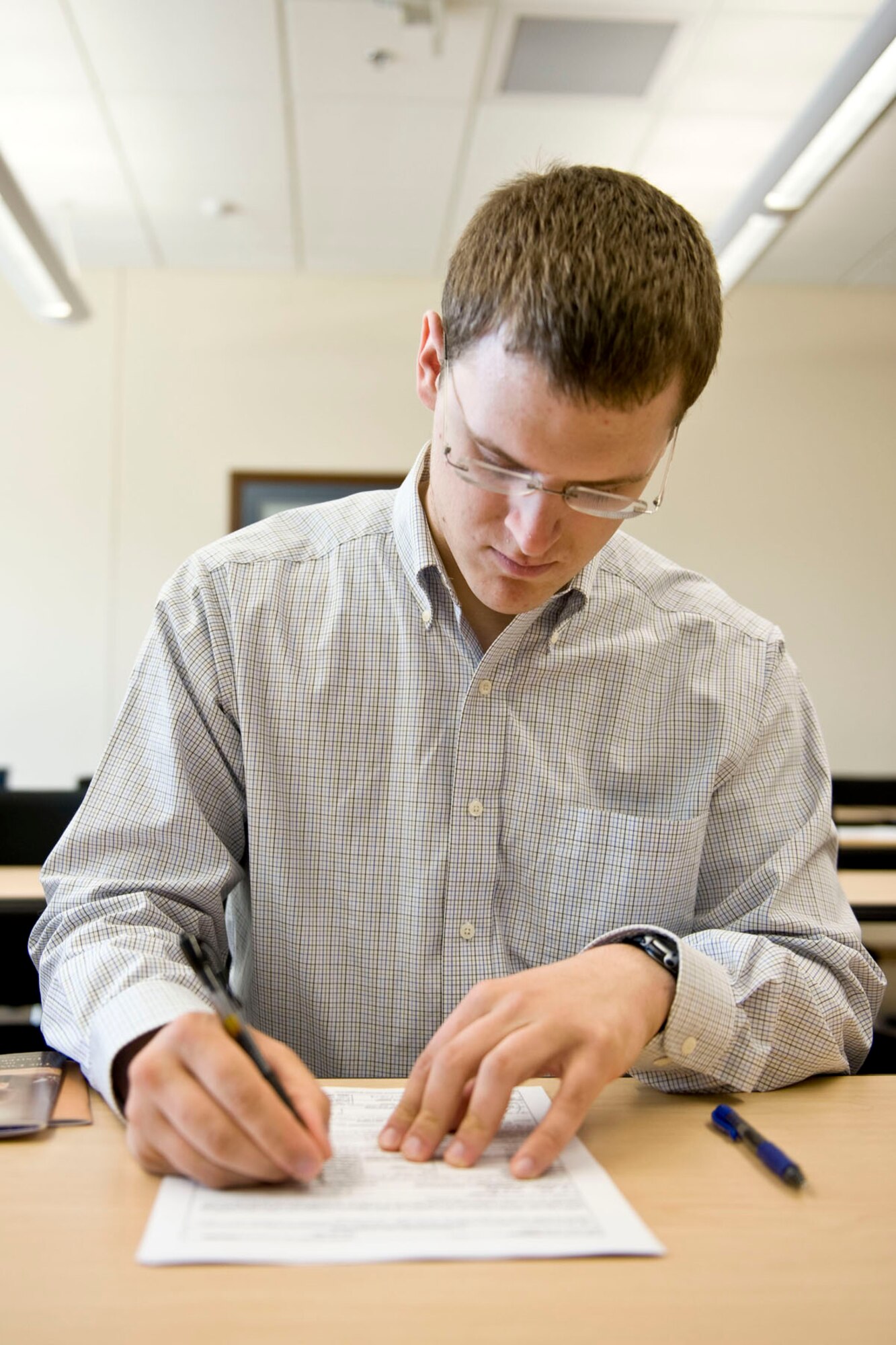 JOINT BASE ELMENDORF-RICHARDSON, Alaska -Alan Mulcahy, a new enlistee for the Alaska Air National Guard, signs his enlistment paperwork June 19, 2012. Mulcahy is scheduled to train as an avionics technician for the 176 Maintenance Squadron. He is enrolled in the University of Alaska Anchorage's Air Traffic Controller program and a 2011 graduate of Chugiak High School.  (National Guard photo by Master Sgt. Shannon Oleson)