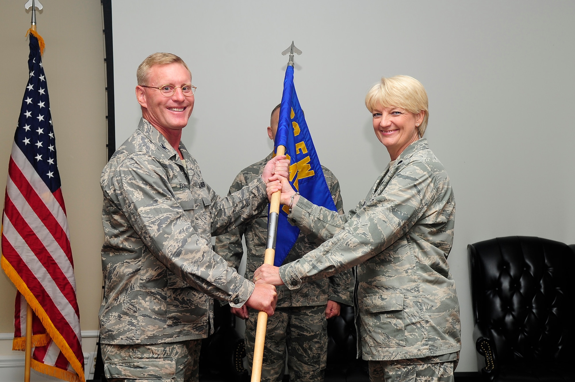 U.S. Air Force Col. Dean Borsos, 20th Medical Group commander, hands the command of the 20th Medical Operations Squadron over to Lt. Col. Colleen Frohling at Shaw Air Force Base, S.C., June 20, 2012. Frohling is the new MDOS commander. Frohling arrived to Shaw from Fort Sam Houston, TX as the chief nurse of the 937th Training Group. (U.S. Air Force photo by Airman 1st Class Hunter Brady/Released)