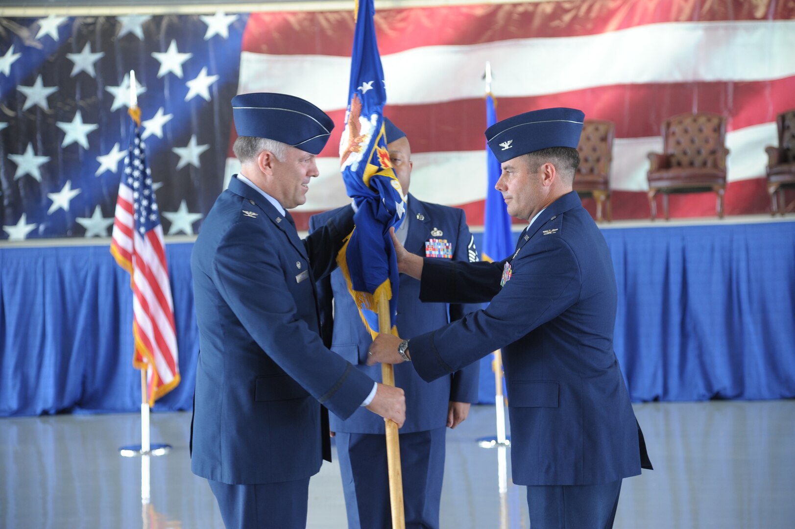 Col. Richard M. Murphy, 12th Flying Training Wing commander, hands over the guidon to Col. David E. Morrissey, during the 12th Operation Group Change of Command ceremony at Joint Base San Antonio-Randolph, TX., June 20.  Col Morrissey is a command pilot with more than 4,100 flight hours in the T-37, T-38A, T-1, C--21A and C-17A. (U.S. Air Force photo by Joel Martinez)