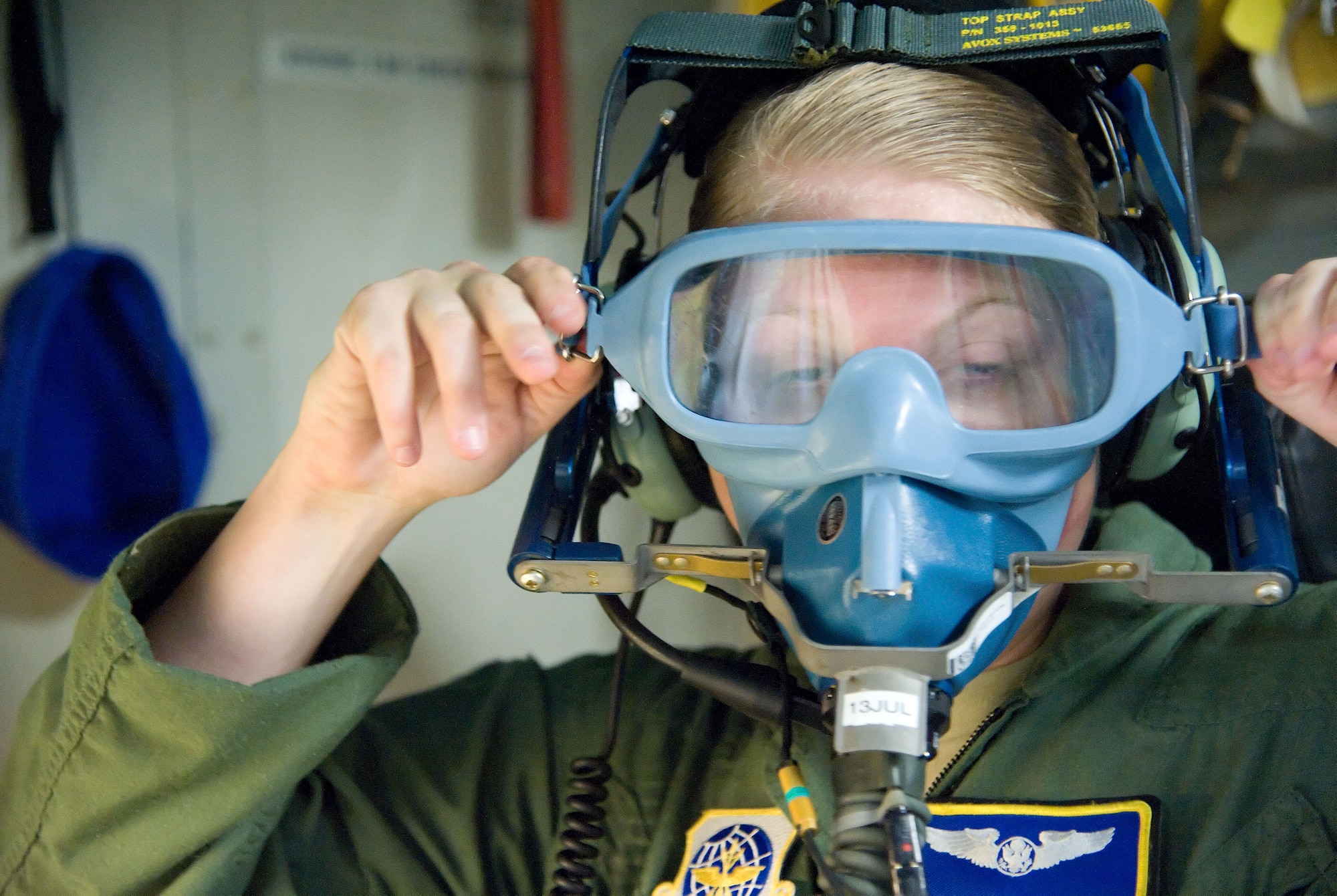 Airman 1st Class Valerie Stephens, a C-17 Globemaster III loadmaster with the 3rd Airlift Squadron, adjusts an oxygen mask before the start of a C-17 training mission June 19, 2012, at Dover Air Force Base, Del. Team Dover frequently flies training missions to ensure flight members remain at optimal mission readiness. (U.S. Air Force photo by Adrian R. Rowan)