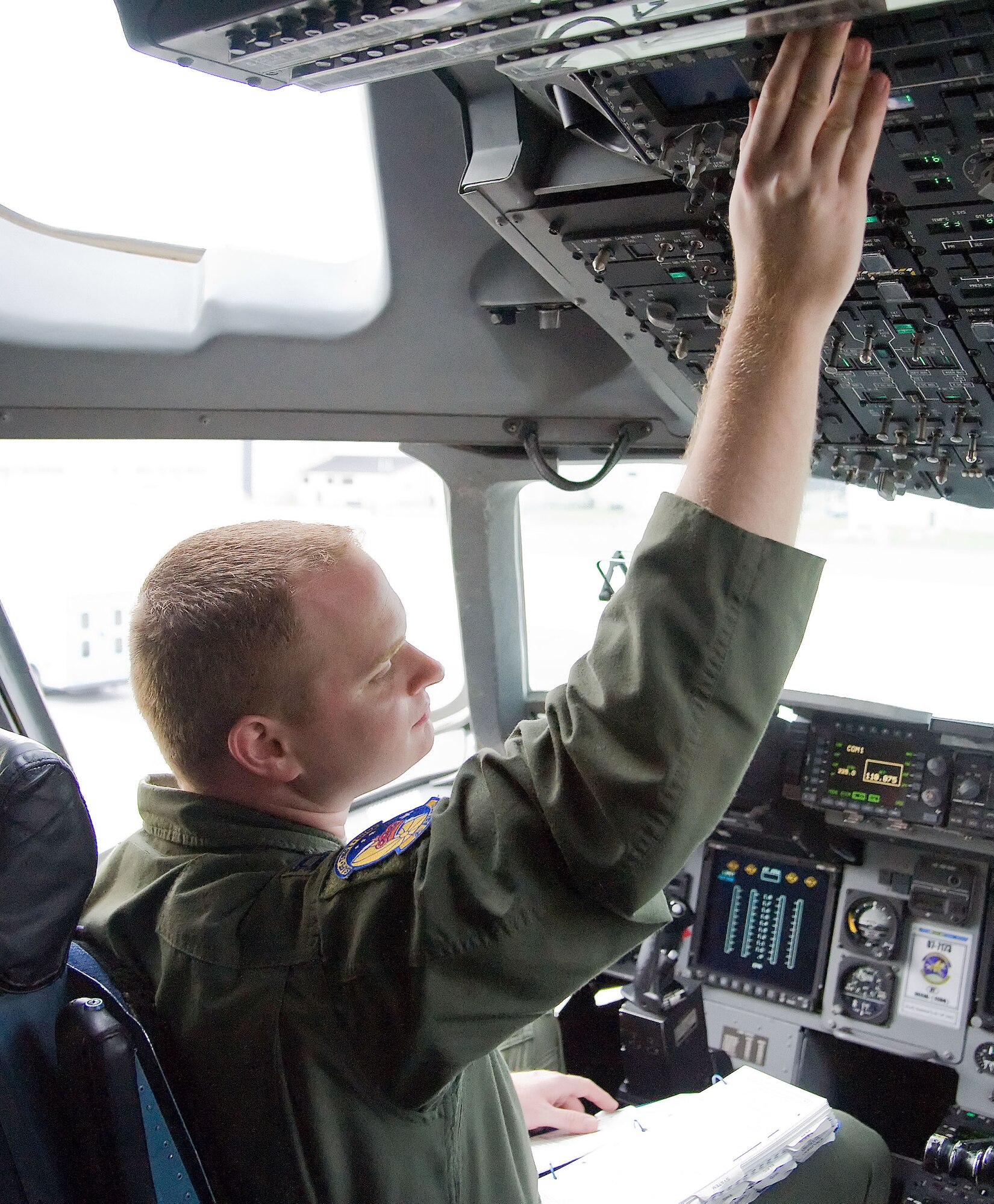Capt. Matthew Celleme, a C-17 Globemaster III pilot with the 3rd Airlift Squadron, conducts pre-flight checks before the start of a C-17 training mission June 19, 2012, at Dover Air Force Base, Del. Team Dover frequently flies training missions to ensure flight members remain at optimal mission readiness. (U.S. Air Force photo by Adrian R. Rowan)
