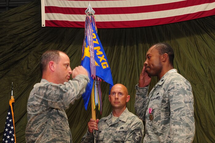 Colonel James Clavenna, 437th Maintenance Group commander, renders a salute to Lt. Col. Luther King, 437th Aerial Port Squadron outgoing commander, during the 437th APS change of command ceremony at Joint Base Charleston - Air Base, S.C, June 19, 2012. (U.S. Air Force photo/ Airman 1st Class Chacarra Walker)