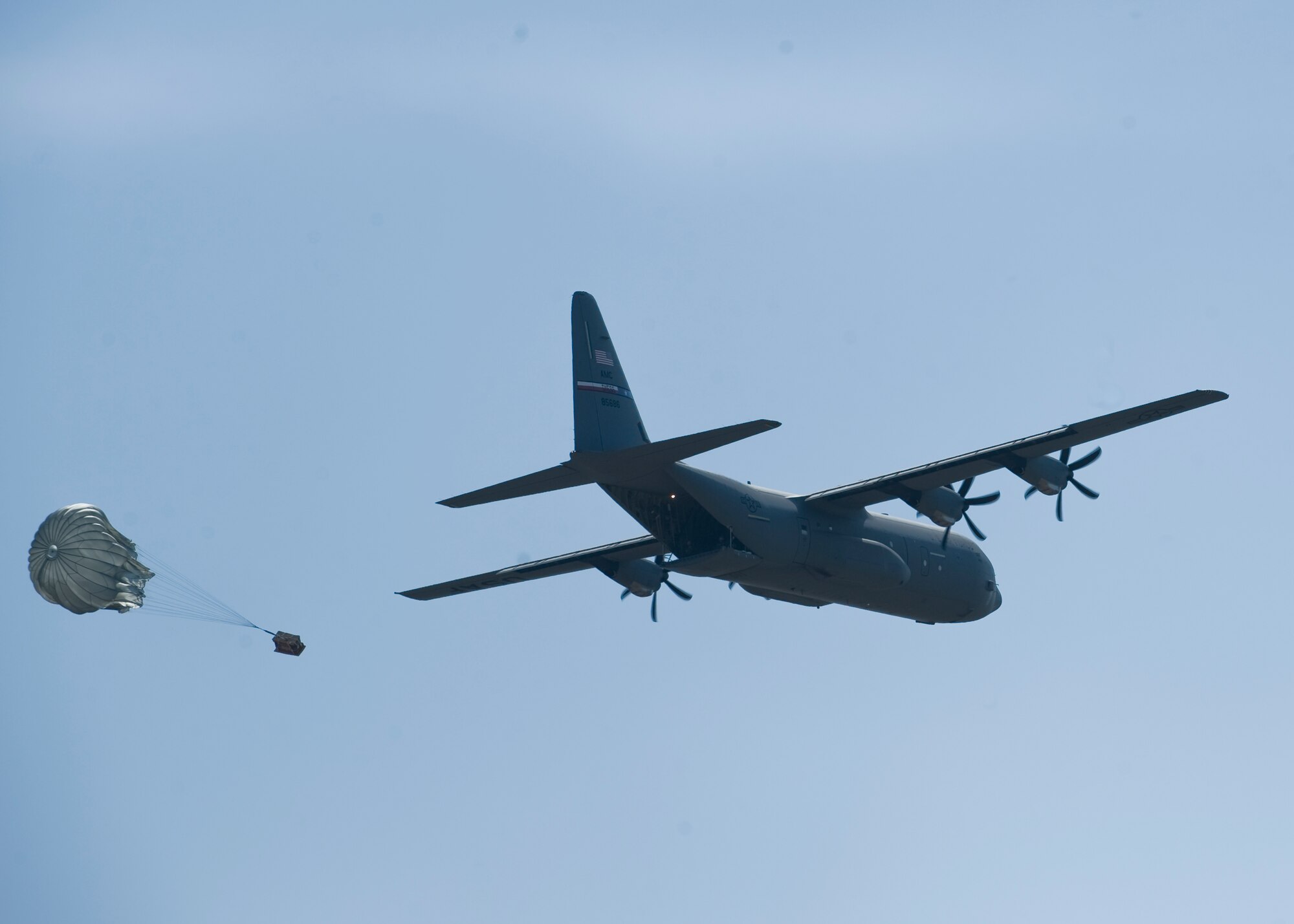 A C-130J Super Hercules airdrops meal, ready-to-eat packages for airmen on Impact Day, June 15, 2012, at the Bronte drop zone in Bronte, Texas. The 317th Airlift Group held Impact Day to allow aircrews and maintainers the opportunity to switch places to experience each other’s work and see the critical role each plays in the Air Force’s mission. (U.S. Air Force photo by Airman 1st Class Peter Thompson/ Released)