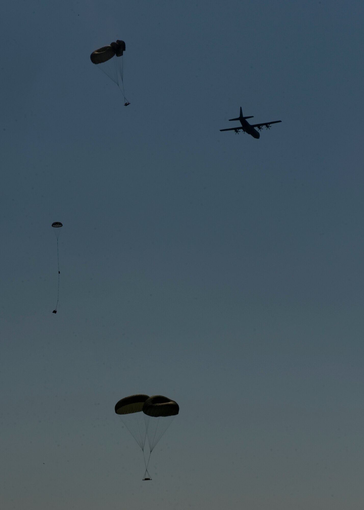 A C-130J Super Hercules flies over the heads of 317th Airlift Group maintainers on Impact Day, June 15, 2012, at the Bronte drop zone in Bronte, Texas. The 317th AG held Impact Day to allow aircrews and maintainers the opportunity to switch places to experience each other’s work and see the critical role each plays in the Air Force’s mission. (U.S. Air Force photo by Airman 1st Class Peter Thompson/ Released)