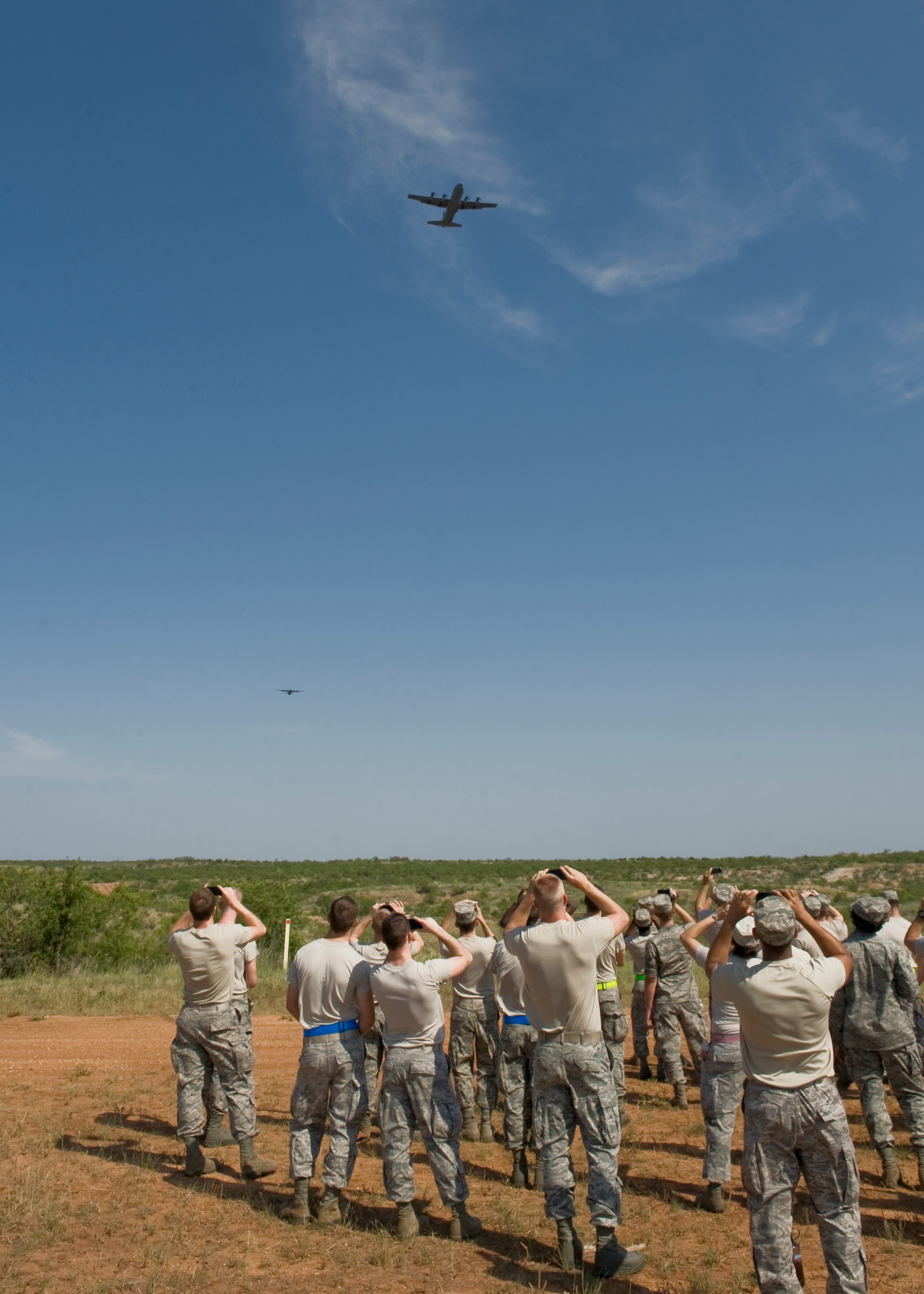 A C-130J Super Hercules airdrops meal, ready-to-eat packages for airmen on Impact Day, June 15, 2012, at the Bronte drop zone in Bronte, Texas. The 317th Airlift Group held Impact Day to allow aircrews and maintainers the opportunity to switch places to experience each other’s work, and see the critical role each plays in the Air Force’s mission. (U.S. Air Force photo by Airman 1st Class Peter Thompson/ Released)