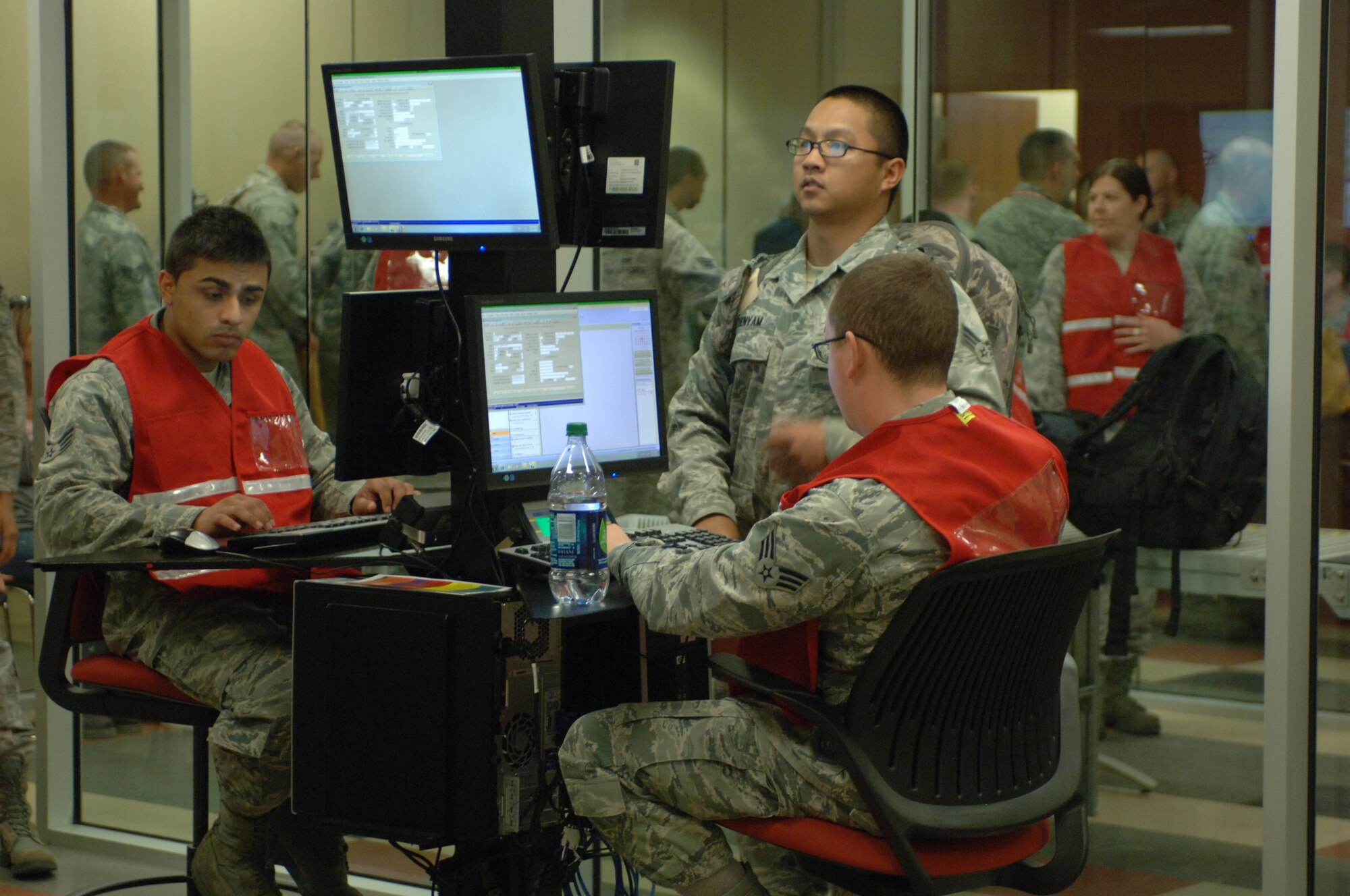 Airmen process through a Personnel Deployment Function line during an Operational Readiness Exercise at Ellsworth AFB, S.D., June 15, 2012. Airmen managing the PDF line in the new deployment center utilize computer-based filing systems to enter, change, and verify a deployer’s important information. (U.S. Air Force photo by Airman 1st Class Zachary Hada/Released)