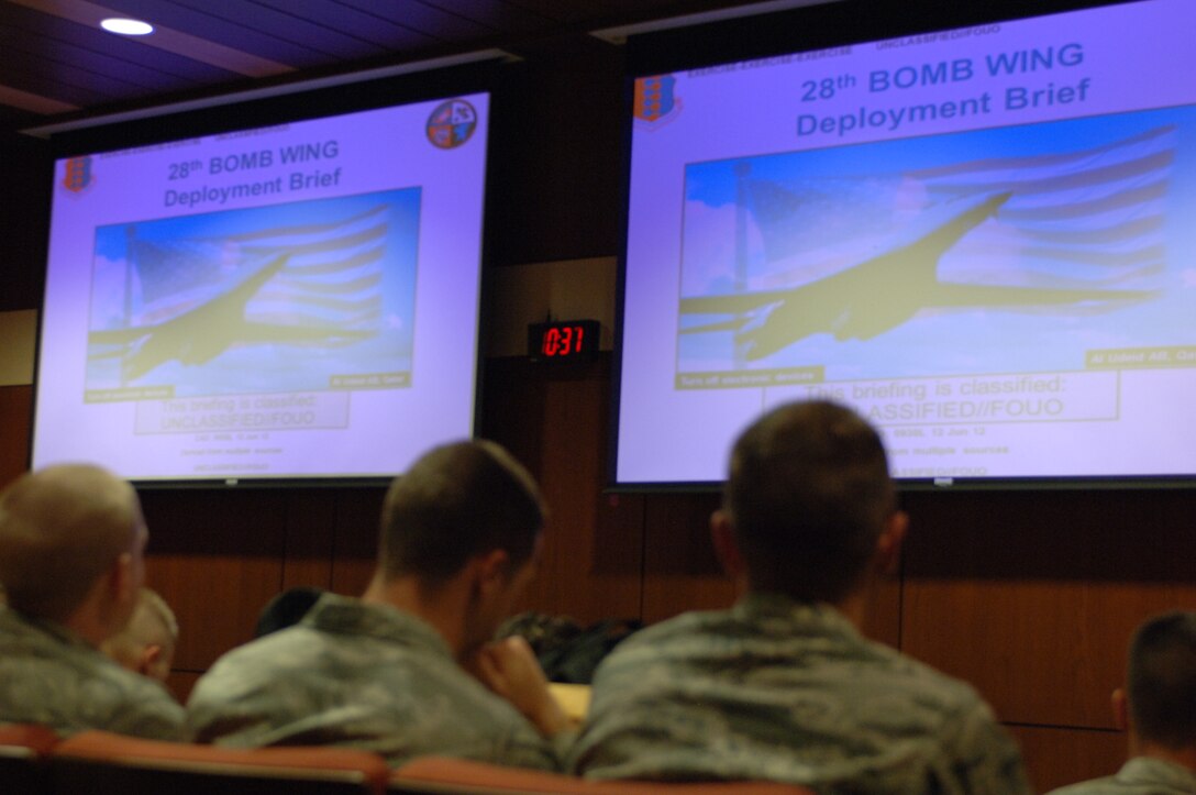 Airmen receive a pre-deployment briefing during an Operational Readiness Exercise at Ellsworth Air Force Base, S.D., June 15, 2012. The new deployment center utilizes state of the art technology to help Airmen process through the deployment lines quickly and efficiently. (U.S. Air Force photo by Airman 1st Class Zachary Hada/Released)