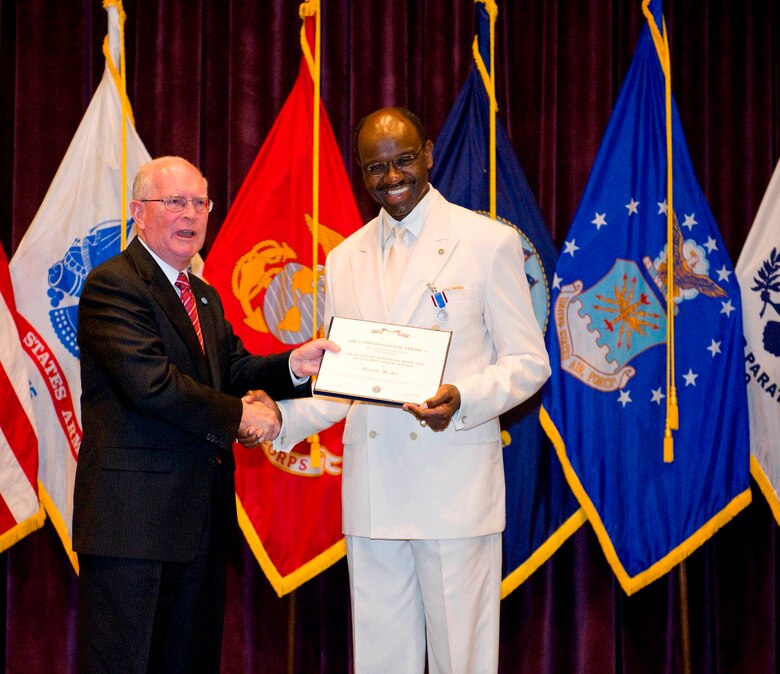 Mr. Ronald M. Joe, DEOMI’s fi rst civilian Principal Director, receives an award from
Mr. Frederick E. Vollrath, Principal Deputy Assistant Secretary of Defense for Readiness and Force Management. Mr. Vollrath served as the presiding offi cer during the ceremony. (Photo by Matthew Jurgens)