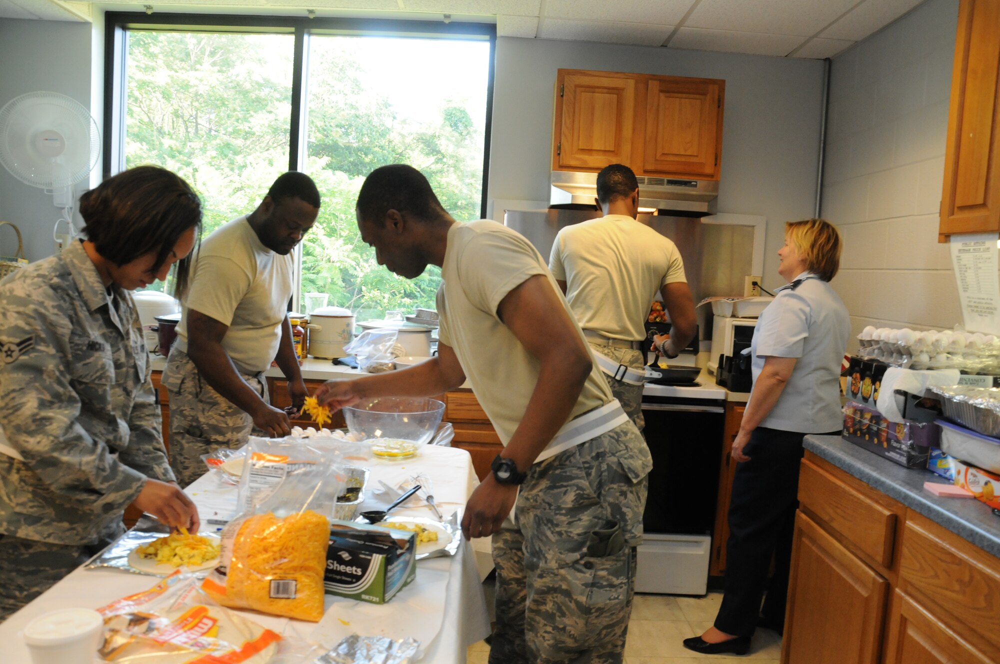 Members from the 459th Air Refueling Wing cook and prepare breakfast burritos for the troops returning from an Operational Readiness Inspection held in Alpena Mich., June 16. The Airmen participated in a week-long inspection where they were evaluated on their ability to perform wartime, contingency and force sustainment missions. The wing received a passing grade of satisfactory for the ORI. (U.S. Air Force photo/ Senior Airman Katie Spencer)