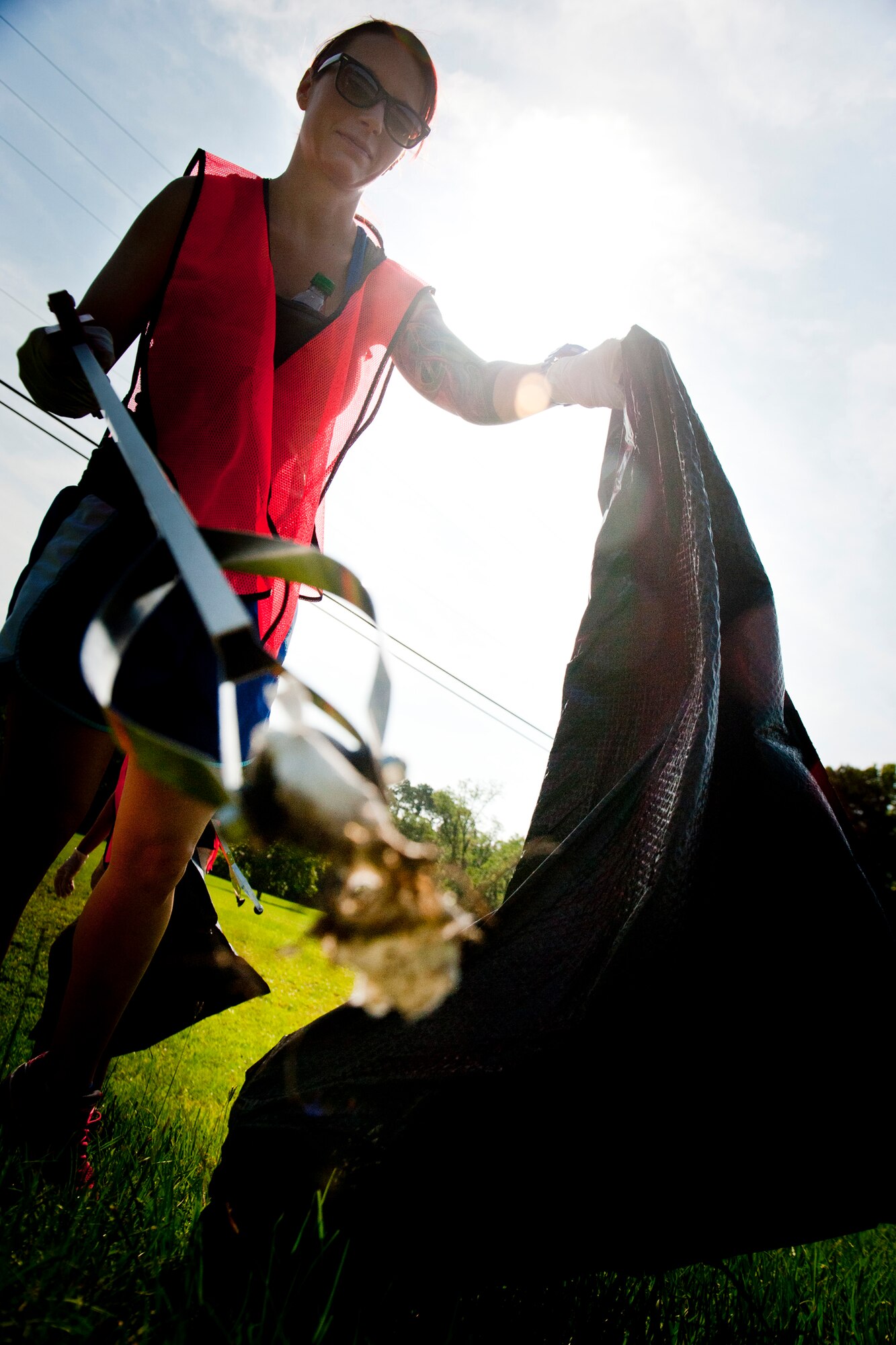 Noel Quinn, wife of U.S. Air Force Maj. Andrew Quinn, 75th Fighter Squadron pilot, collects trash along Old Highway 41 South as part of an Adopt-A-Road program June 13, 2012, in Valdosta, Ga. The group is responsible for cleaning the highway four times a year but has volunteered to pick up debris as frequently as necessary. (U.S. Air Force photo by Staff Sgt. Jamal D. Sutter/Released)
