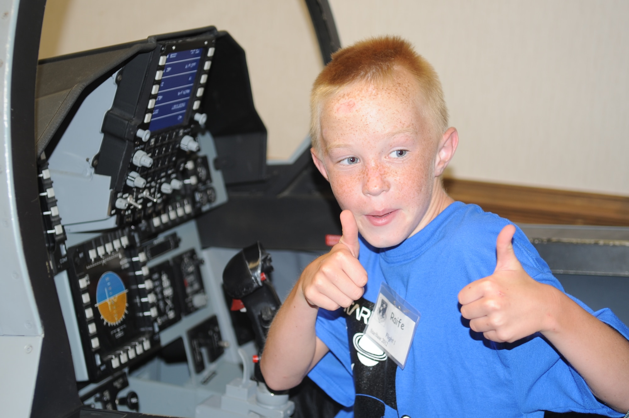 Raife Stanton gives thumbs up while sitting in an egress trainer during a Science and Technology Academies Reinforcing Basic Aviation and Space Exploration tour on Seymour Johnson Air Force Base, N.C., June 18, 2012. As part of STARBASE students learn how science applies to duties performed by Airmen on a daily basis. Raife is the son of U.S. Air Force Master Sgt. Daniell Stanton, 4th Logistics Readiness Squadron deployments section chief, and hails from Goldsboro, N.C. (U.S. Air Force photo/Senior Airman Gino Reyes/Released)