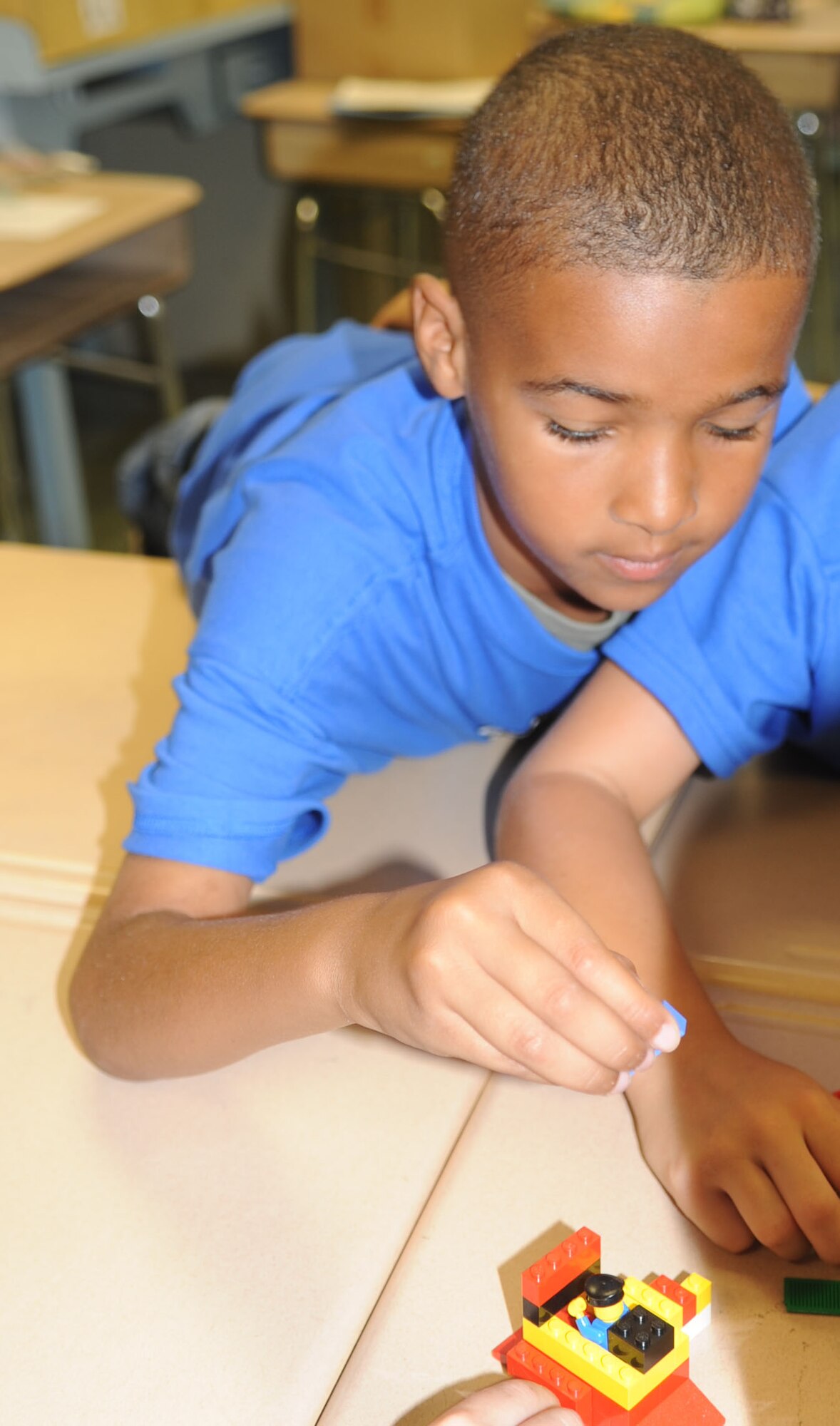 Savian Proctor participates in a team building exercise during the Science and Technology Academies Reinforcing Basic Aviation and Space Exploration program at Meadow Lane Elementary school in Goldsboro, N.C., June 18, 2012. Savian and his team had to accomplish the exercise with one hand behind their backs to demonstrate the importance of teamwork. Savian is the son of U.S. Air Force Staff Sgt. Marco Proctor, 4th Civil Engineer Squadron structural journeyman, and hails from Goldsboro. (U.S. Air Force photo/Senior Airman Gino Reyes/Released)