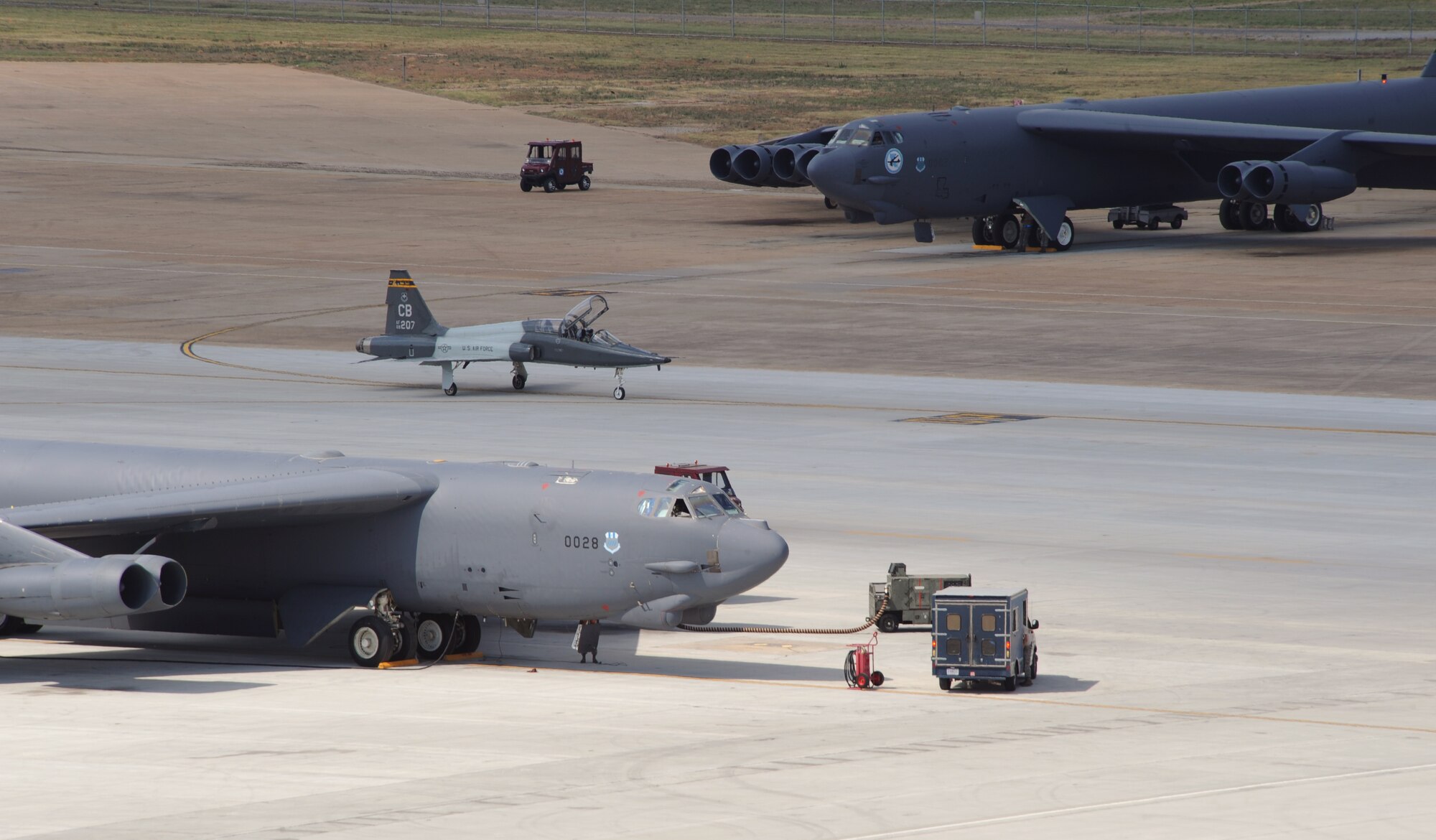 A T-38A Talon from Columbus Air Force Base, Miss., sit between two B-52H Stratofortress bombers during an exercise at Barksdale Air Force Base, La., June 5. Even when the 2nd Bomb Wing participates in an exercise, the transient alert team takes care of military and commercial aircraft that need refueling, emergency repairs and attention. (U.S. Air Force photo/Airman 1st Class Benjamin Gonsier)(RELEASED)
